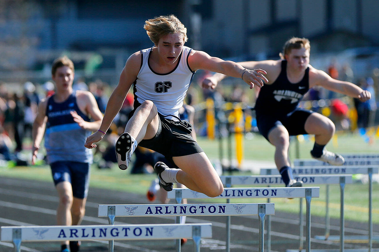 Runners compete in the 300 meter hurdle during the Chuck Randall Invite at Arlington High School on Saturday, March 18, 2023, in Arlington, Washington. (Ryan Berry / The Herald)