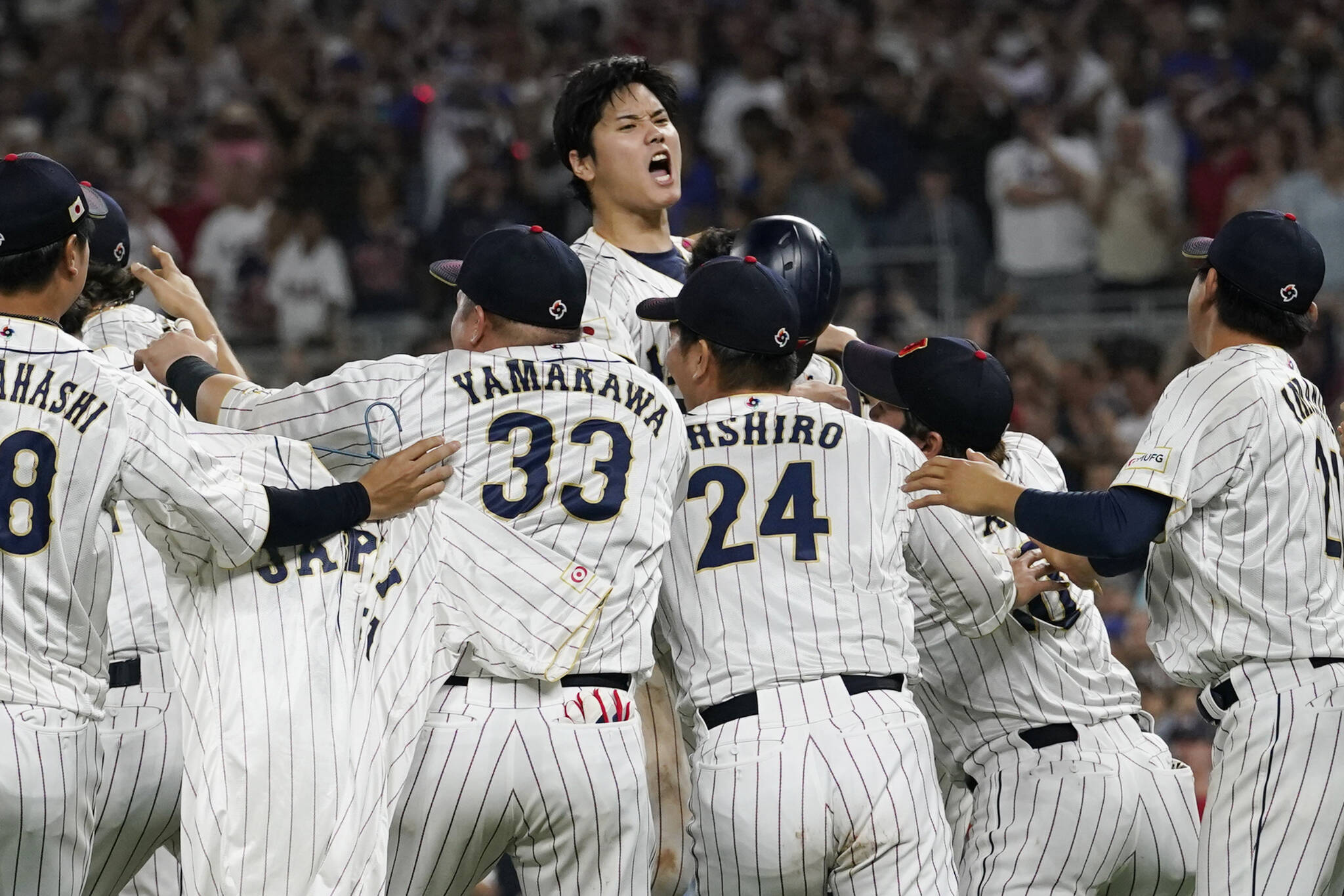 Japan pitcher Shohei Ohtani (center) celebrates with teammates after defeating the United States in the World Baseball Classic championship game Tuesday in Miami. (AP Photo/Marta Lavandier)