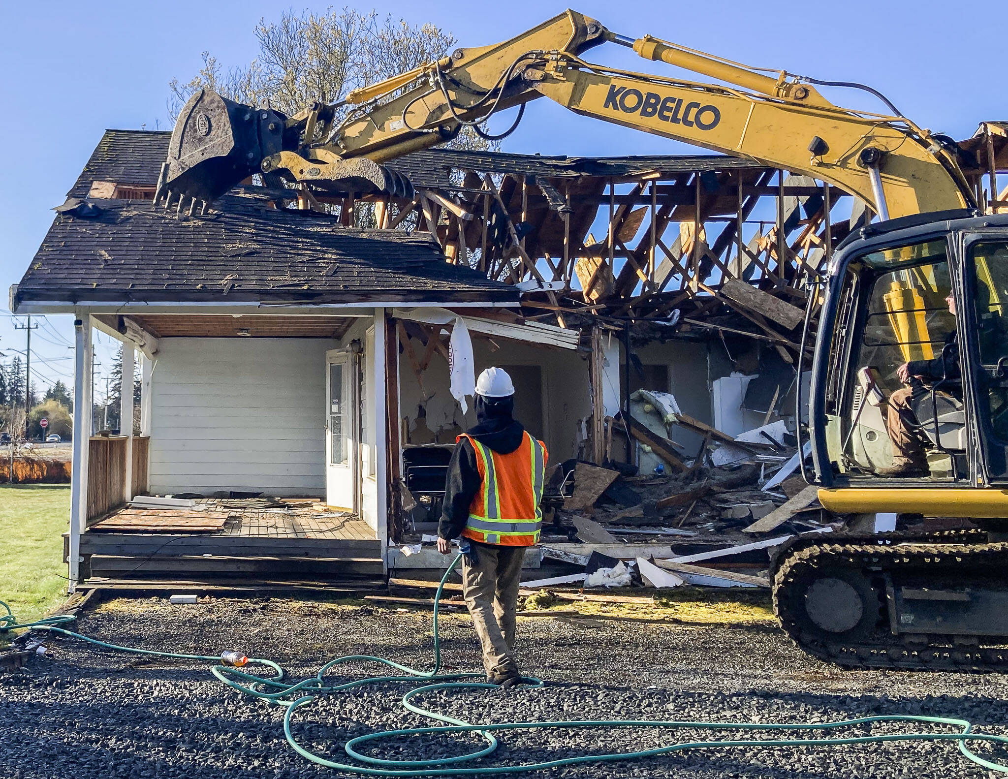 A residential home is demolished at what will be the site of a new Lake Stevens Library on Wednesday, March 22, 2023 in Lake Stevens, Washington. (Sophia Gates / The Herald).