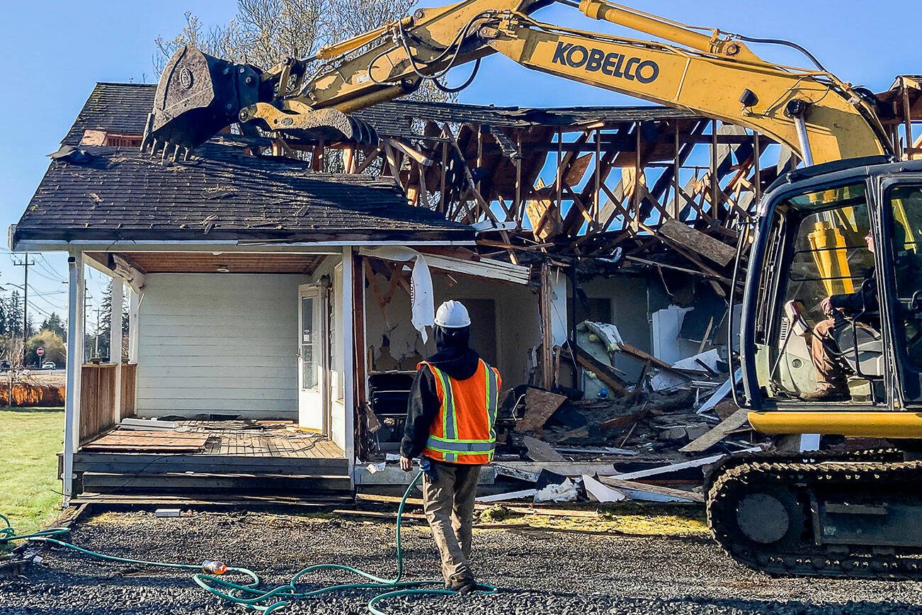 A residential home is demolished at what will be the site of a new Lake Stevens Library on Wednesday, March 22, 2023 in Lake Stevens, Washington. (Sophia Gates / The Herald).