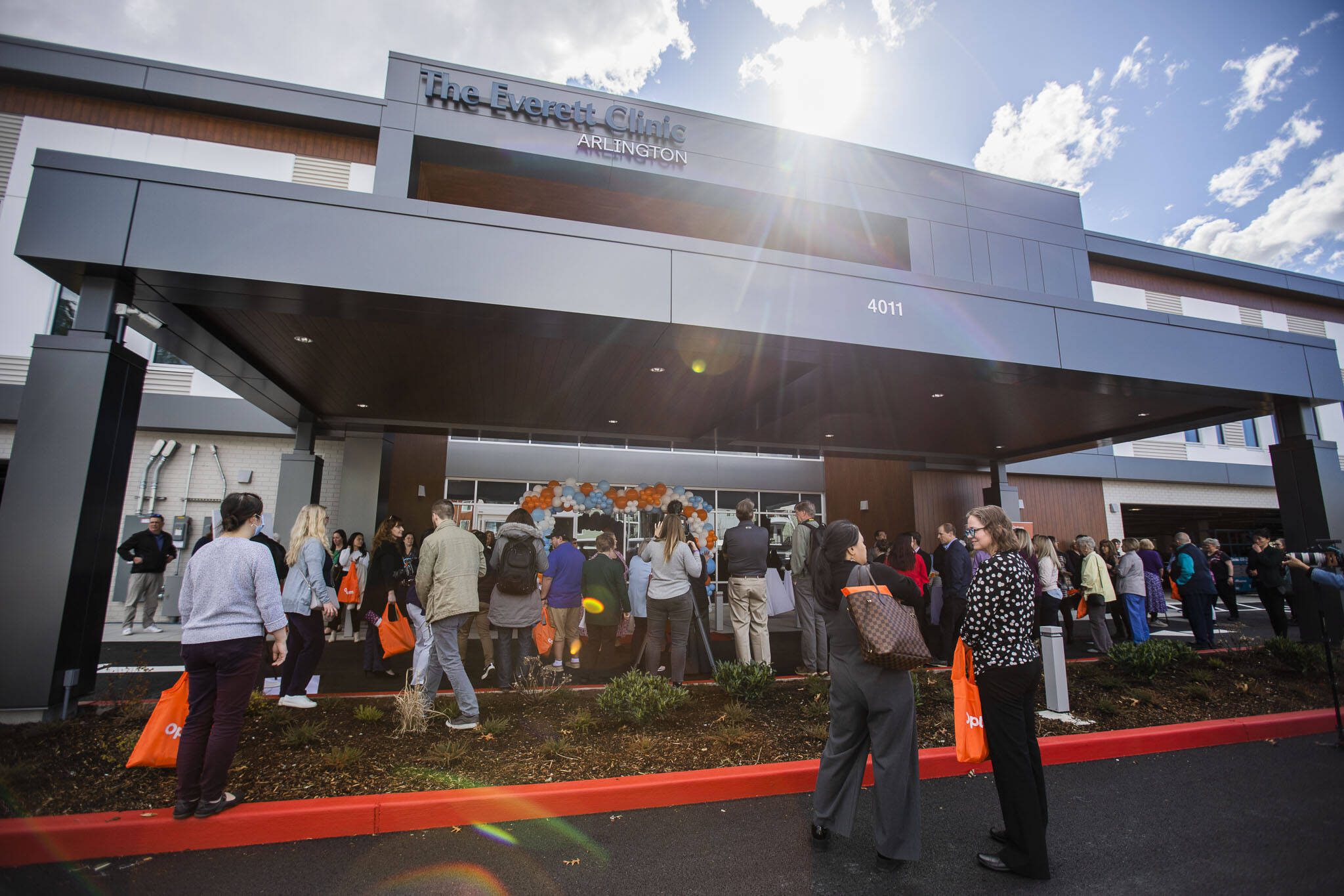People gather outside of the new Everett Clinic in Arlington for its opening on Monday, March 27, 2023 in Arlington, Washington. (Olivia Vanni / The Herald)