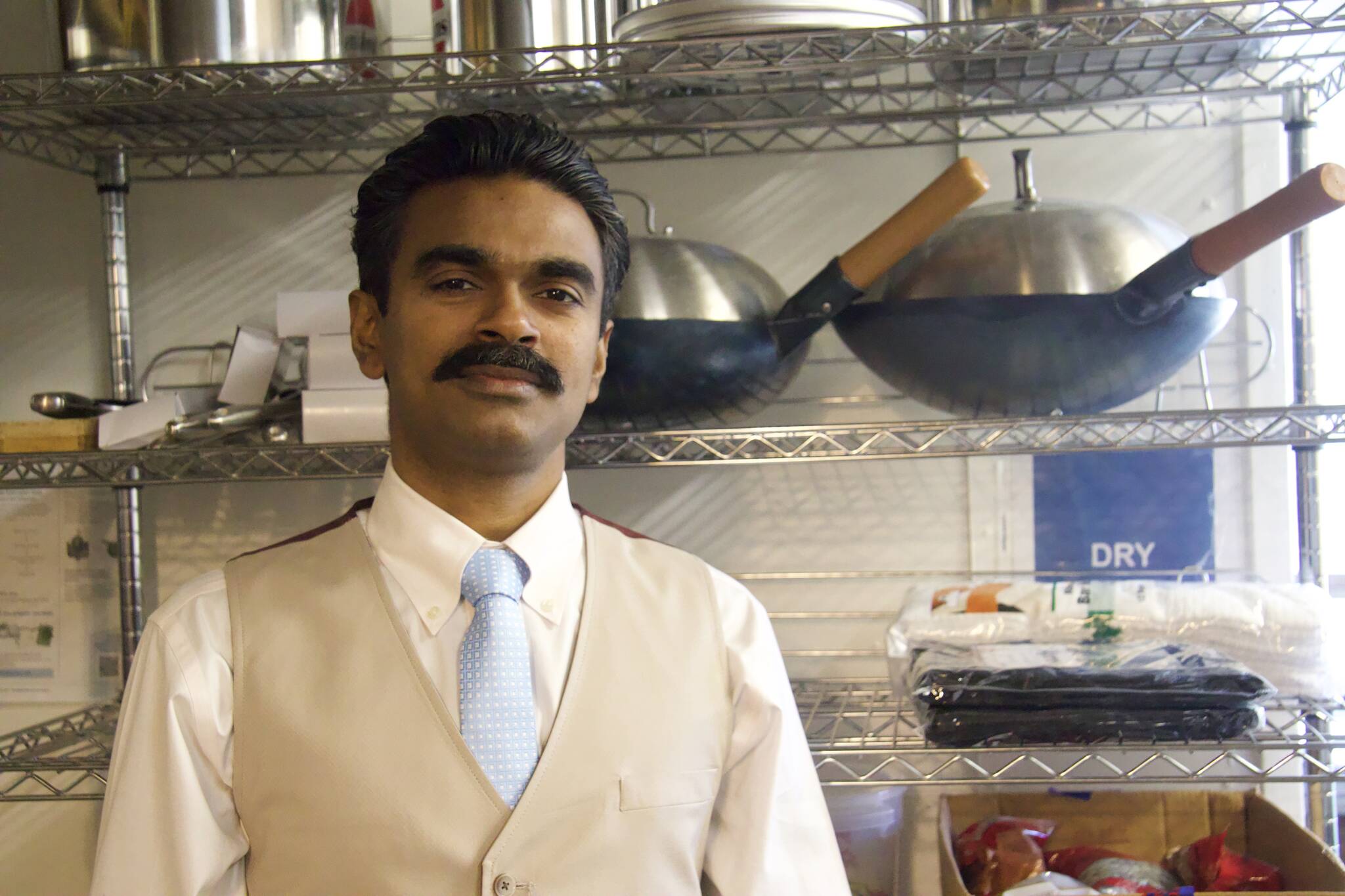 Manu Unni stands in the kitchen of his new restaurant, Unni’s Kitchen. (Rachel Rosen / Whidbey News-Times)