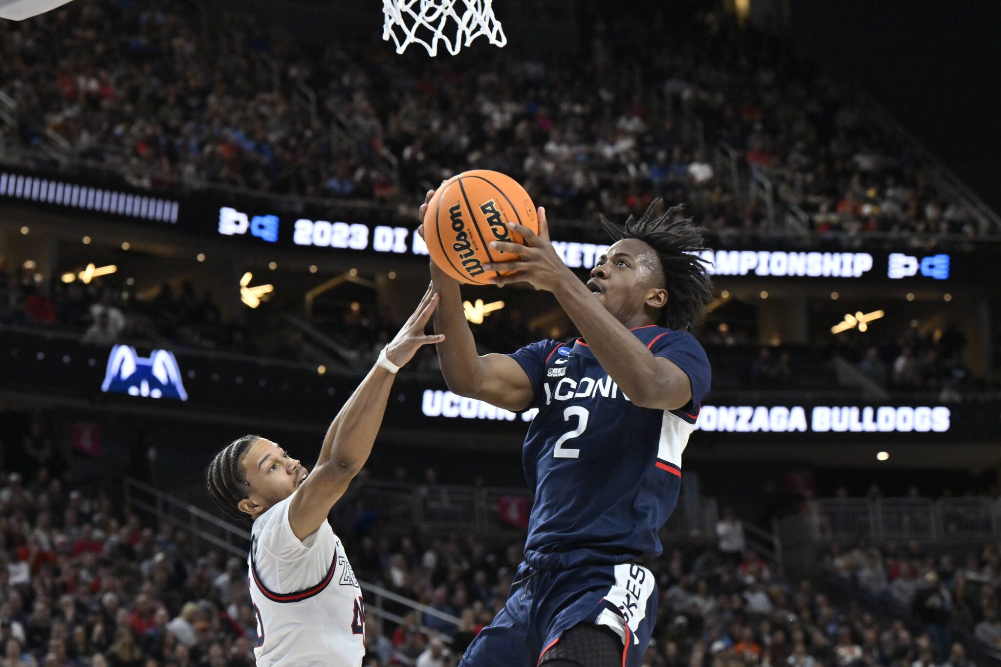 UConn guard Tristen Newton (2) shoots while defended by Gonzaga guard Rasir Bolton in the first half of an Elite 8 game of the NCAA Tournament on Saturday in Las Vegas. (AP Photo/David Becker)