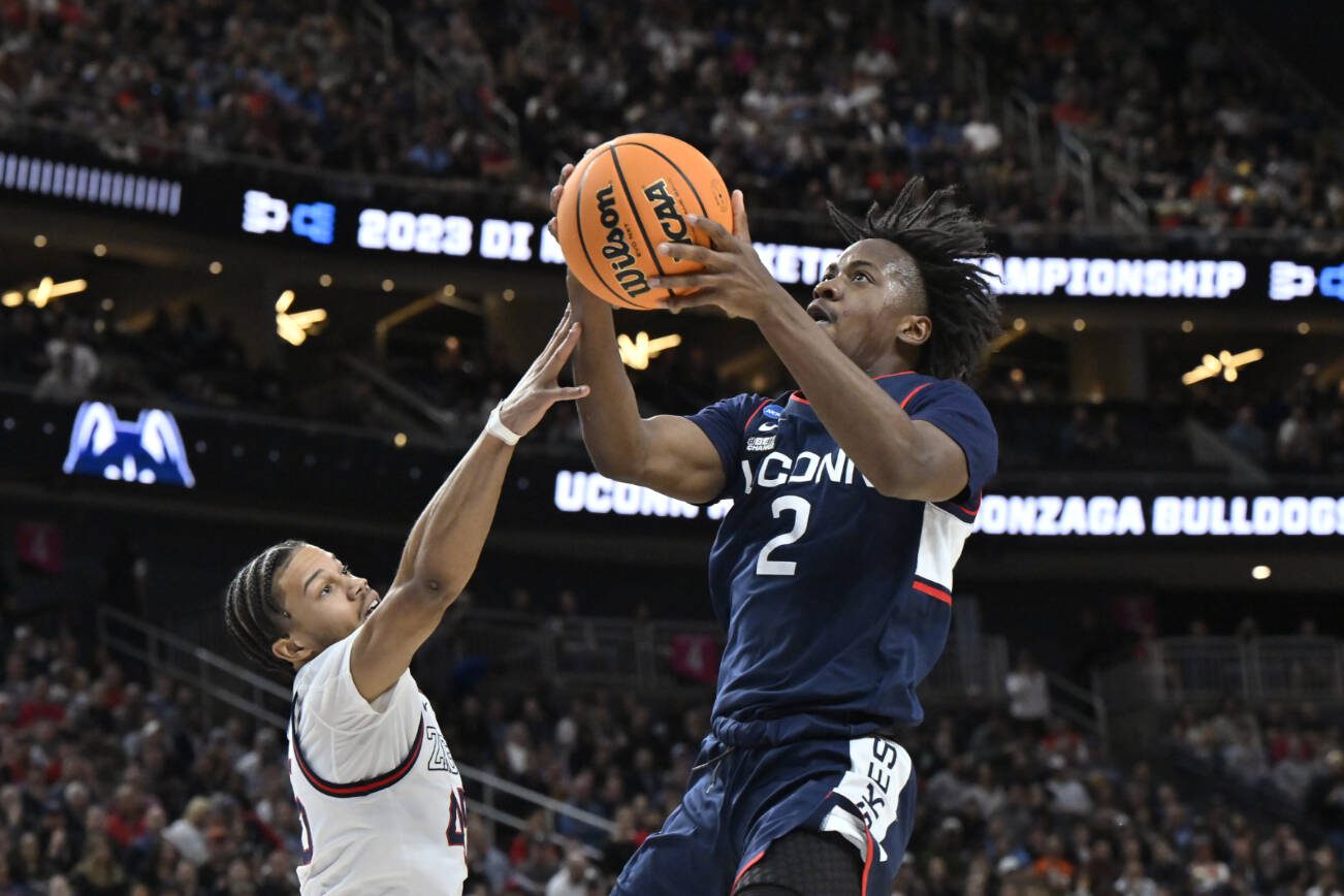UConn guard Tristen Newton (2) shoots while defended by Gonzaga guard Rasir Bolton in the first half of an Elite 8 college basketball game in the West Region final of the NCAA Tournament, Saturday, March 25, 2023, in Las Vegas. (AP Photo/David Becker)