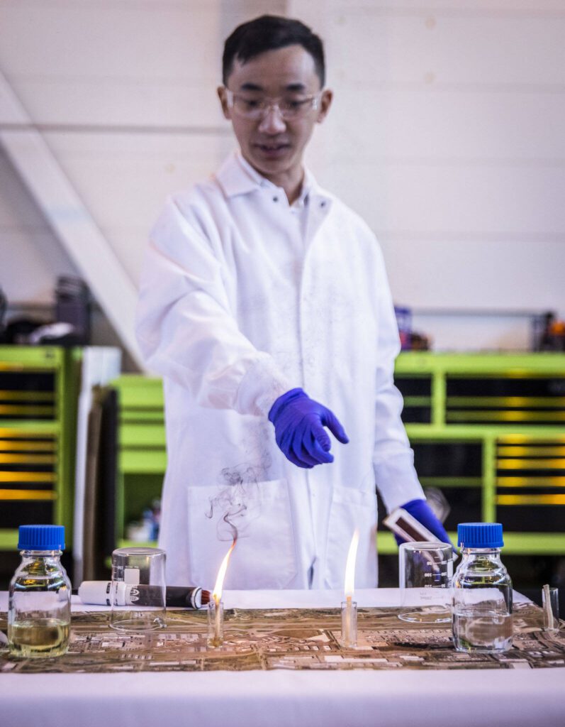 Harrison Yang, a PHD student at WSU Tri-Cities demonstrates emission differences between jet fuels on Tuesday, March 28, 2023 in Everett, Washington. (Olivia Vanni / The Herald)
