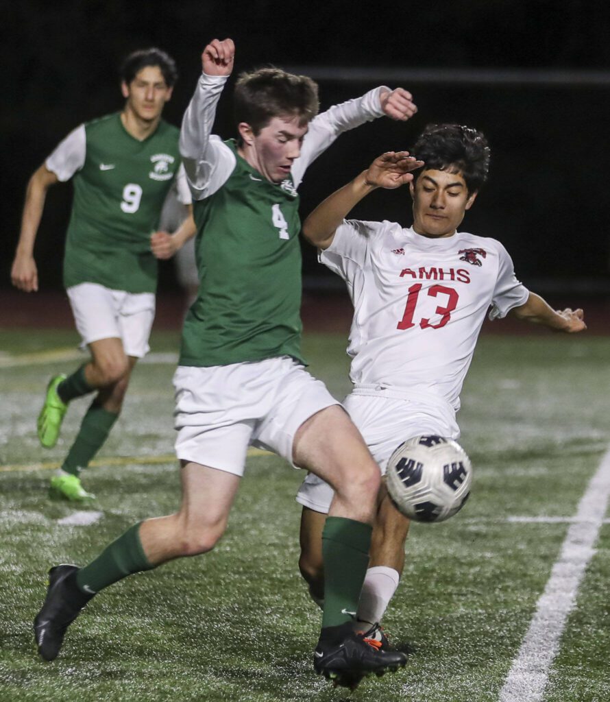 Archbishop Murphy’s Ivan Hernandez Vazquez (13) and Edmonds-Woodway’s Anthony Pellegrini (4) fight for the ball during a boys soccer match between Archbishop Murphy and Edmonds-Woodway at Edmonds-Wooday High School in Edmonds, Washington on Tuesday, March 28, 2023. Edmonds-Woodway won, 4-1. (Annie Barker / The Herald)
