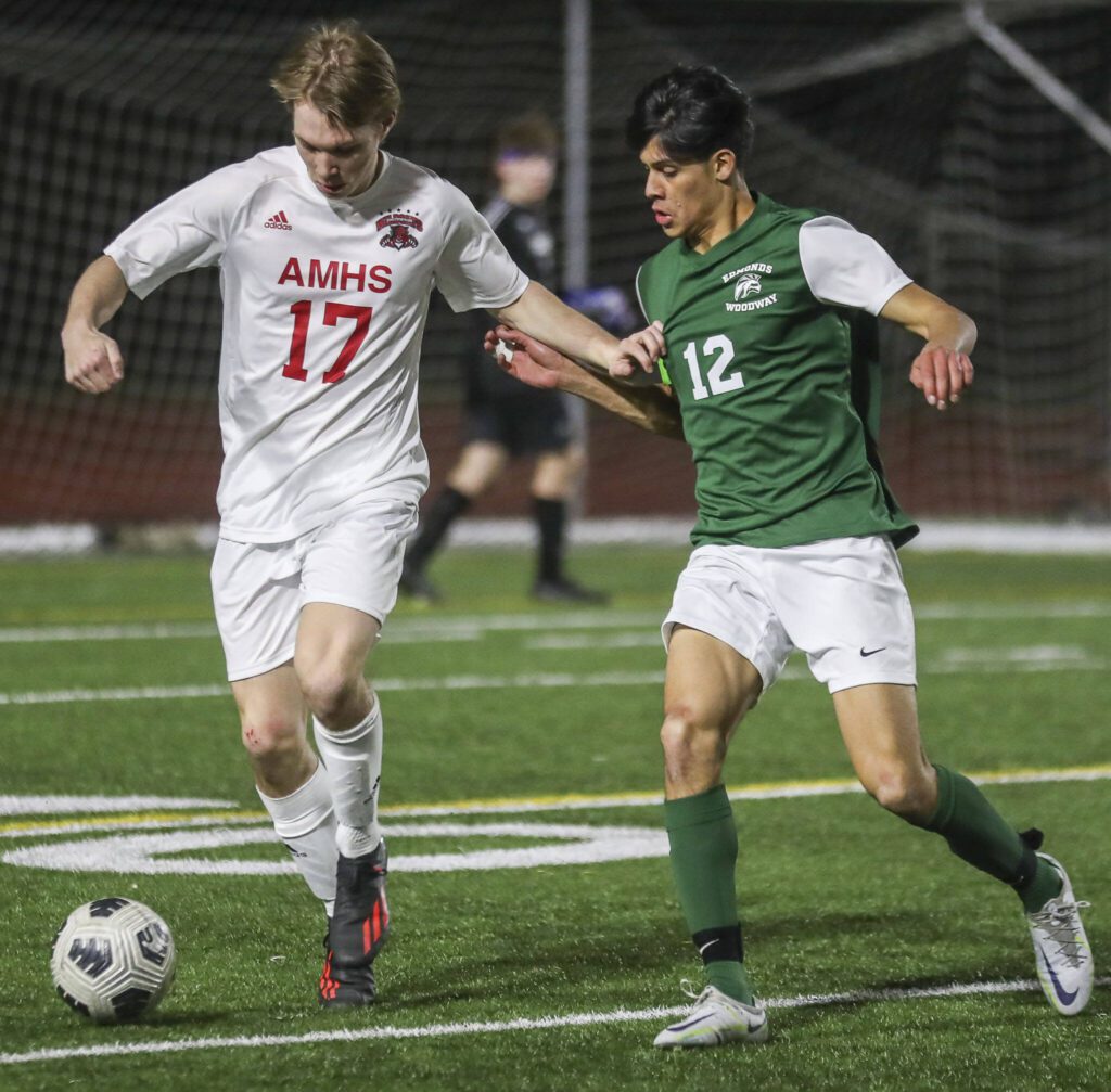 Archbishop Murphy’s Ryan Hall (17) and Edmonds-Wooday’s Victor Ibarra (12) fight for the ball during a boys soccer match between Archbishop Murphy and Edmonds-Woodway at Edmonds-Wooday High School in Edmonds, Washington on Tuesday, March 28, 2023. Edmonds-Woodway won, 4-1. (Annie Barker / The Herald)
