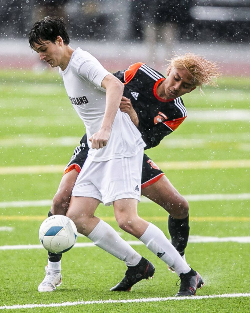Monroe’s Brayan Ojeda-Gaspar battles Mercer Island’s Leo Berkley for the ball during a Class 3A state semifinal May 27, 2022, in Puyallup. (Olivia Vanni / The Herald)

