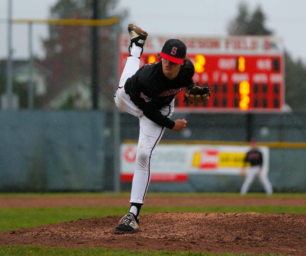 Snohomish’s Jackson Weeks almost loses his hat while pitching against Glacier Peak on Friday, March 31, 2023, at Earl Torgeson Field in Snohomish, Washington. (Ryan Berry / The Herald)
