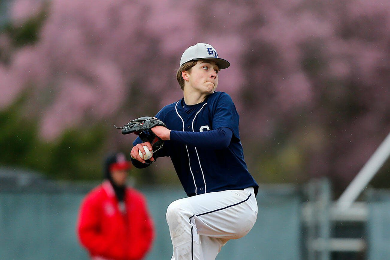 Glacier Peak’s Owen Gluth winds up to deliver a pitch against Snohomish on Friday, March 31, 2023, at Earl Torgeson Field in Snohomish, Washington. (Ryan Berry / The Herald)