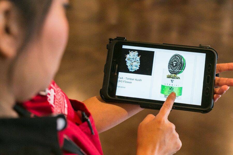 Wiyanna Benally demonstrates the tablet use at Tulalip Remedy in Tulalip on Aug. 22, 2018.  (Kevin Clark / The Herald)