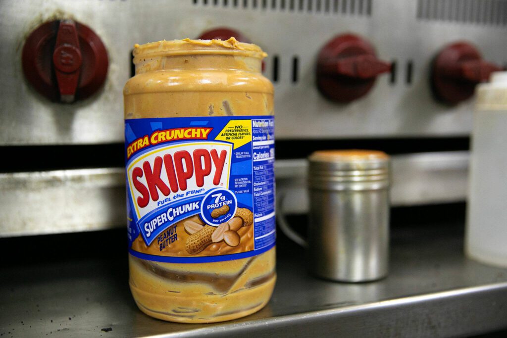 Skippy Super Chunk is the peanut butter of choice for Nick’s Jr.’s peanut butter bacon burger on Friday, March 31, 2023, at his restaurant in Everett, Washington. (Ryan Berry / The Herald)
