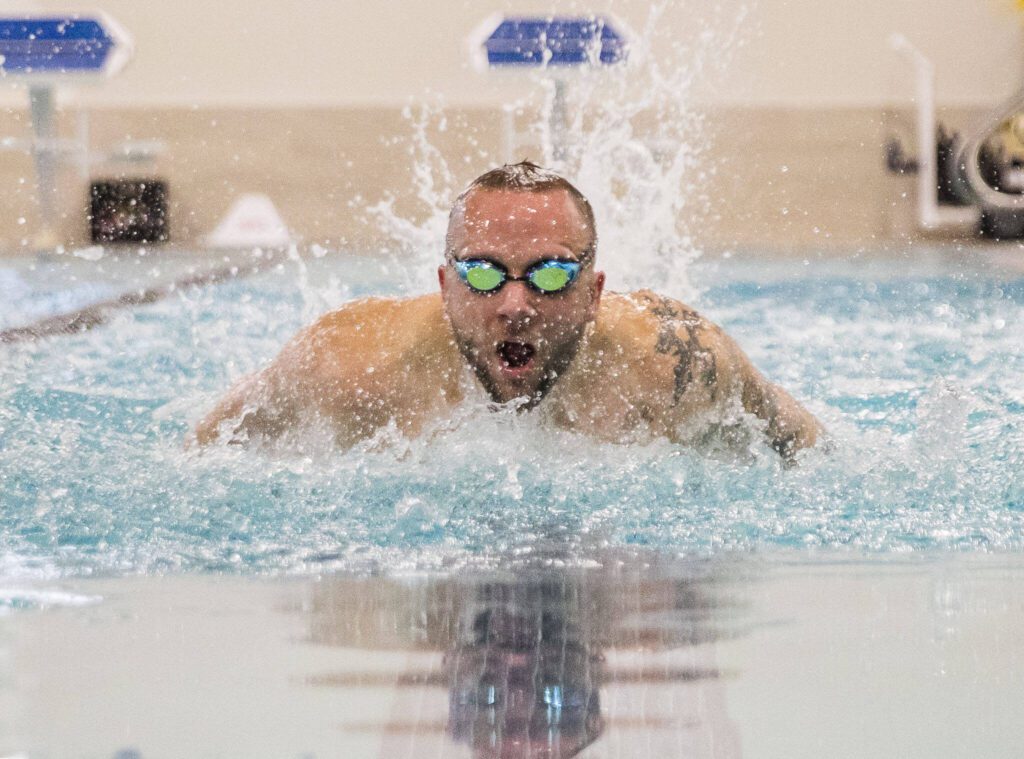 James Hessen swims the butterfly during a practice at the Everett YMCA on Friday, March 17, 2023 in Everett, Washington. (Olivia Vanni / The Herald).
