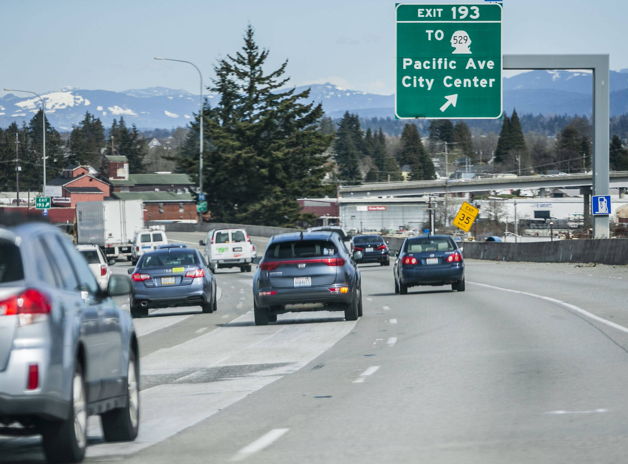 A driver merges into the far right lane on northbound Interstate 5 heading toward the U.S. 2 trestle exit on Tuesday, March 28, 2023 in Everett, Washington. (Olivia Vanni / The Herald)