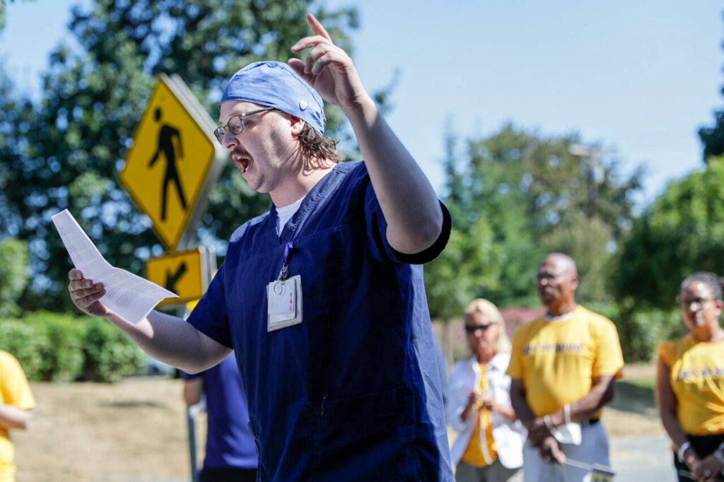 Trevor Gjendem addresses a gathering a hospital staff members, supporters and elected officials in Everett, Washington on August 24, 2022. (Kevin Clark / The Herald)
