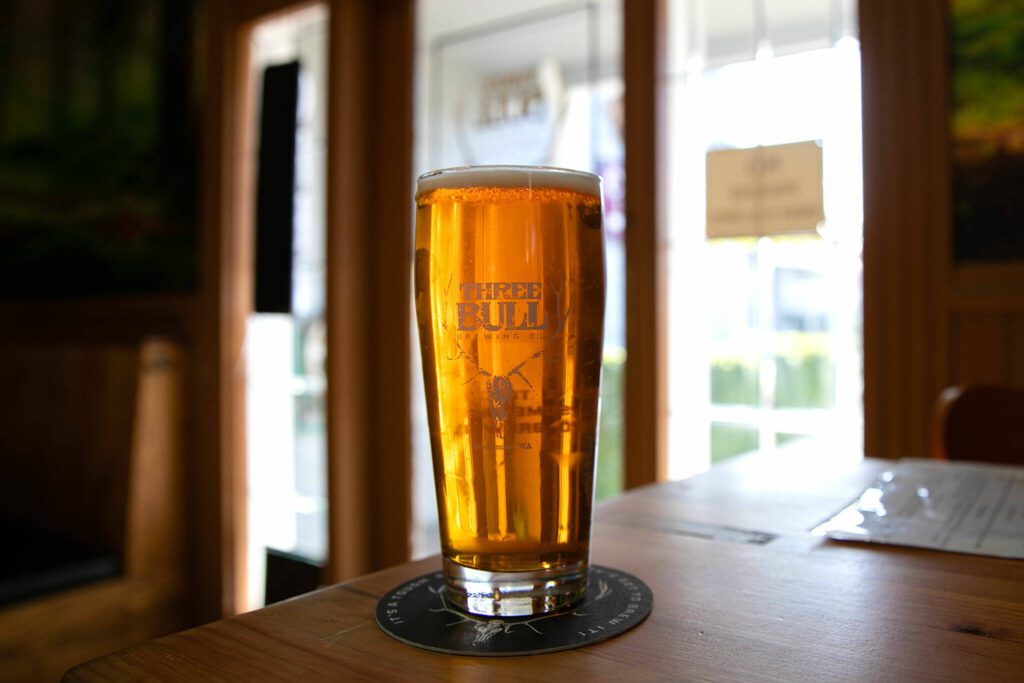 Three Bull’s flagship IPA, the first beer they ever made, sits on a table at the new tap house on Wednesday, April 19, 2023, in Snohomish, Washington. (Ryan Berry / The Herald)

