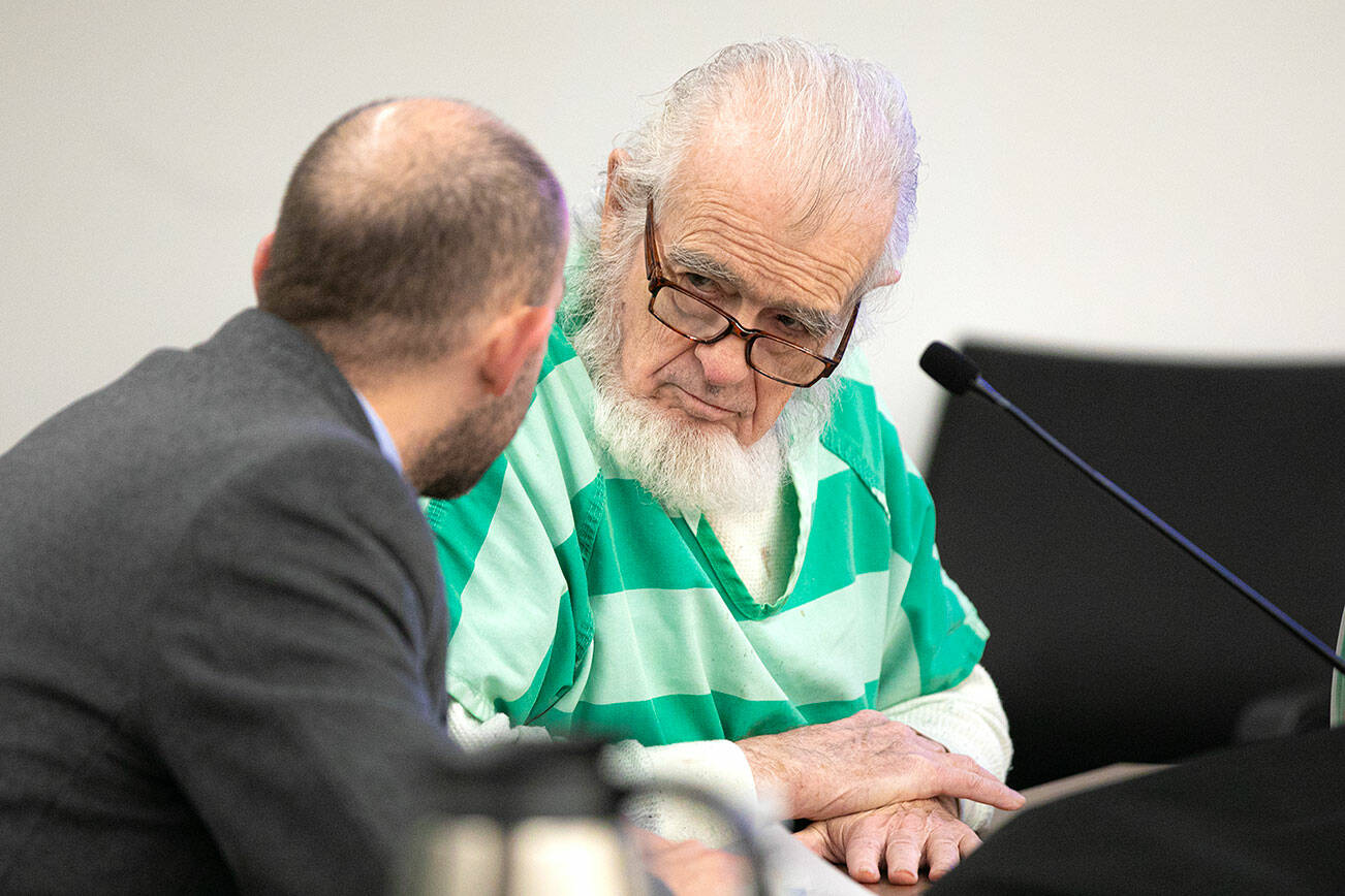 Lloyd Richmond speaks with his lawyer after arriving in court Tuesday, April 4, 2023, at Snohomish County Superior Court in Everett, Washington. (Ryan Berry / The Herald)