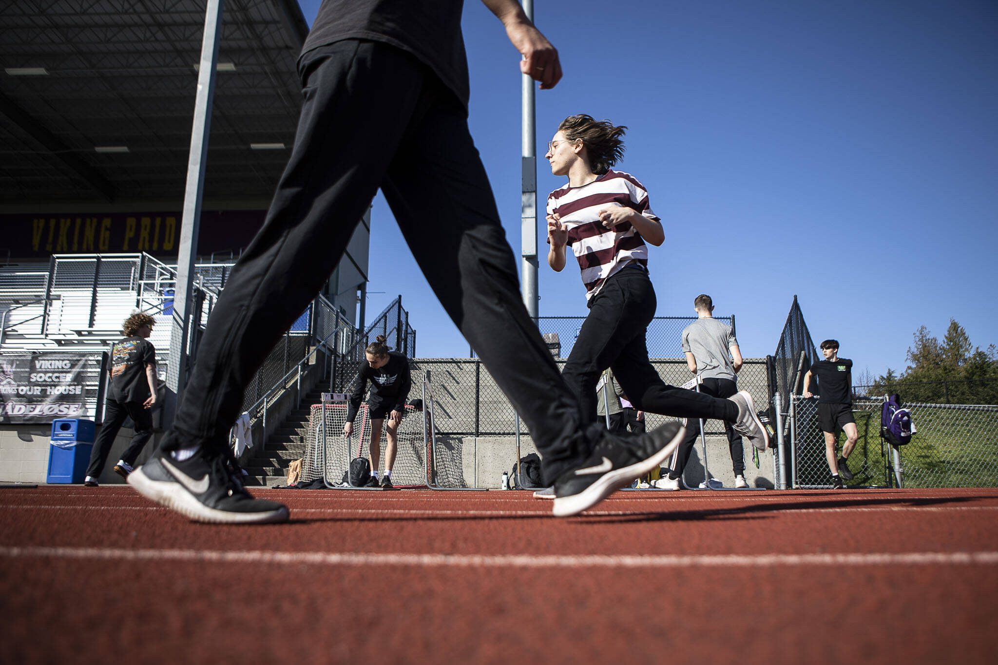 Hurdlers run exercises during a track and field practice after school at Lake Stevens High School in Lake Stevens, Washington on Wednesday, March 22, 2023. The team has over 300 members. (Annie Barker / The Herald)