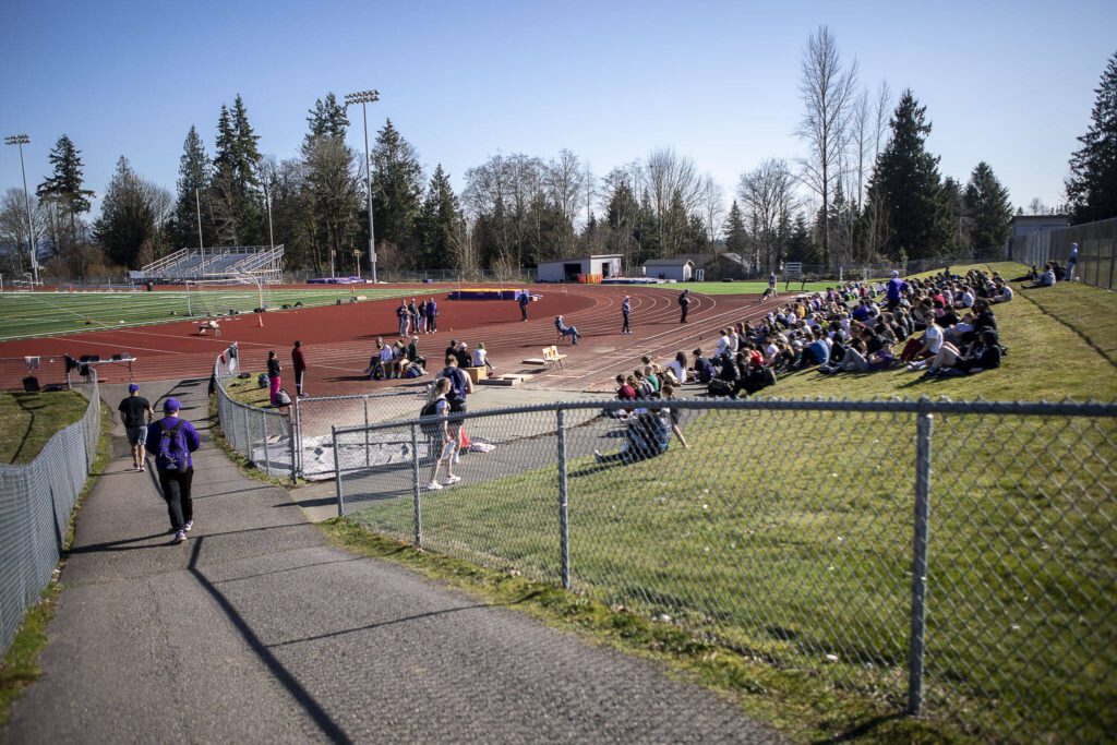 Track and field athletes listen to coaches speak during practice after school at Lake Stevens High School in Lake Stevens, Washington on Wednesday, March 22, 2023. The team has over 300 members. (Annie Barker / The Herald)
