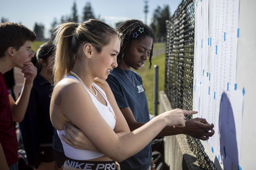 Track and field athletes check to see what events and races they are participating in during practice after school at Lake Stevens High School in Lake Stevens, Washington on Wednesday, March 22, 2023. The team has over 300 members. (Annie Barker / The Herald)
