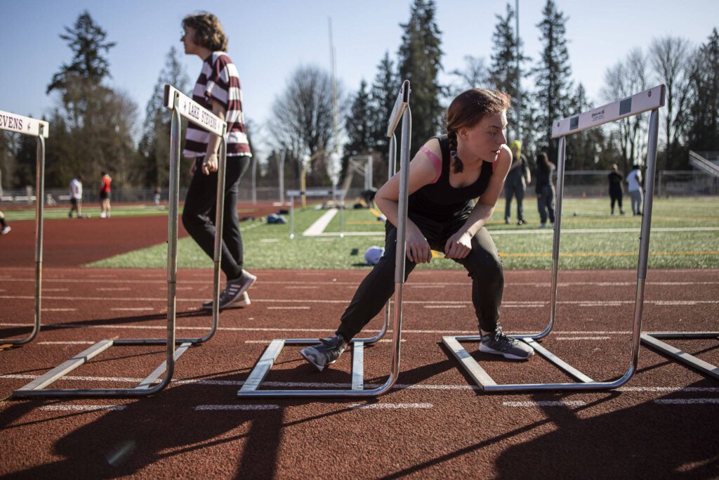 Hurdlers run exercises during a track and field practice after school at Lake Stevens High School in Lake Stevens, Washington on Wednesday, March 22, 2023. The team has over 300 members. (Annie Barker / The Herald)

