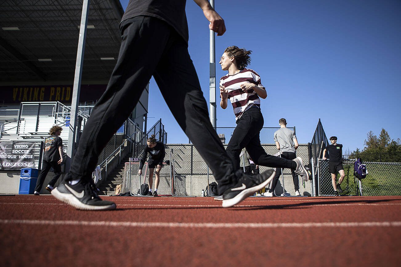 Hurdlers run exercises during a track and field practice after school at Lake Stevens High School in Lake Stevens, Washington on Wednesday, March 22, 2023. The team has over 300 members. (Annie Barker / The Herald)