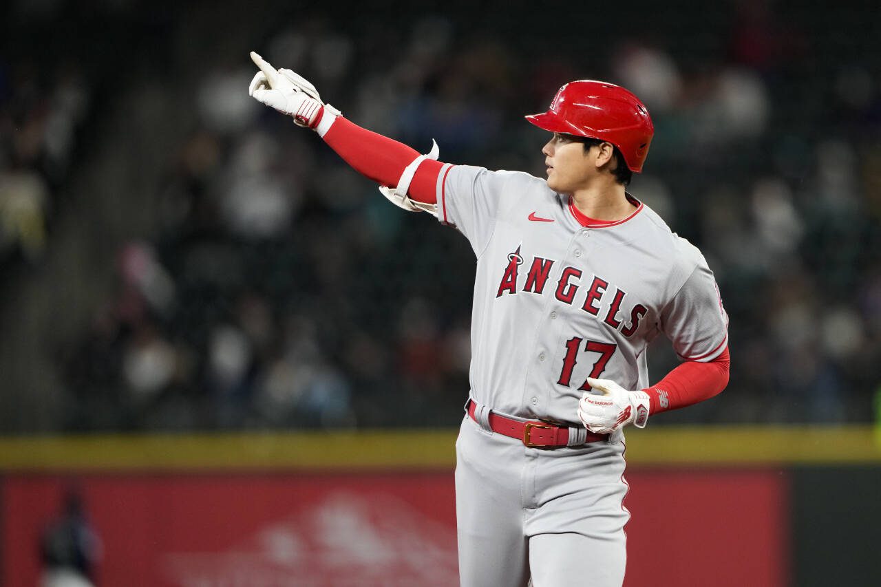 Los Angeles Angels designated hitter Shohei Ohtani points to the outfield as he runs the bases after hitting a two-run home run against the Seattle Mariners in the fifth inning of a game Monday in Seattle. (AP Photo/Lindsey Wasson)