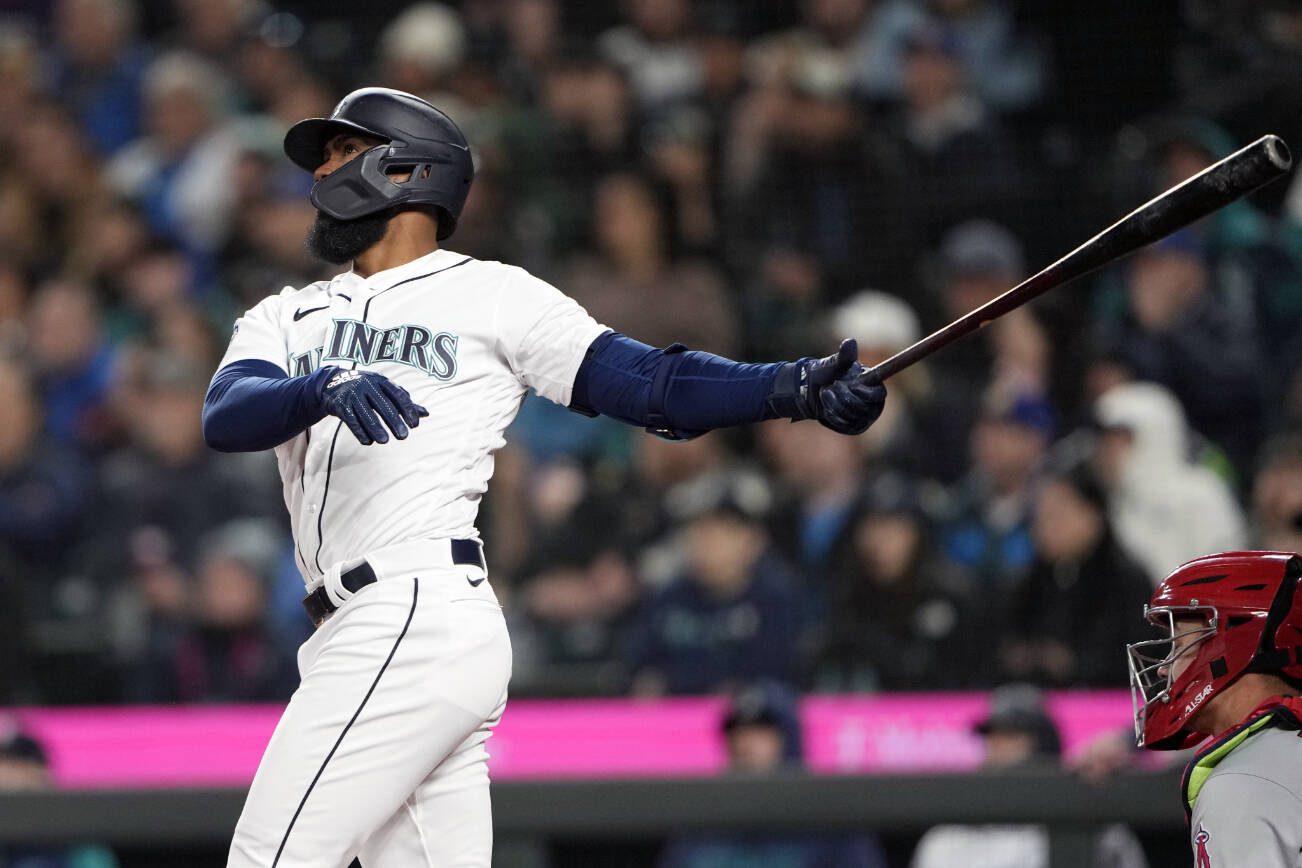 Seattle Mariners' Teoscar Hernandez follows through on a three-run home run, his second home run of the game, against the Los Angeles Angels during the fifth inning of a baseball game Tuesday, April 4, 2023, in Seattle. (AP Photo/Lindsey Wasson)