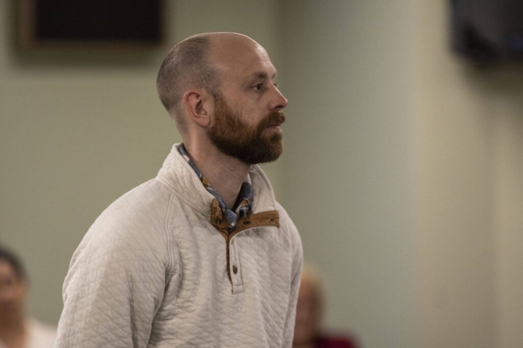Snohomish County Human Services Planner Tyler Verda listens at Hope Church in Everett, Washington on Wednesday, April 5, 2023. The church will potentially be converted to a low barrier homeless shelter. (Annie Barker / The Herald)
