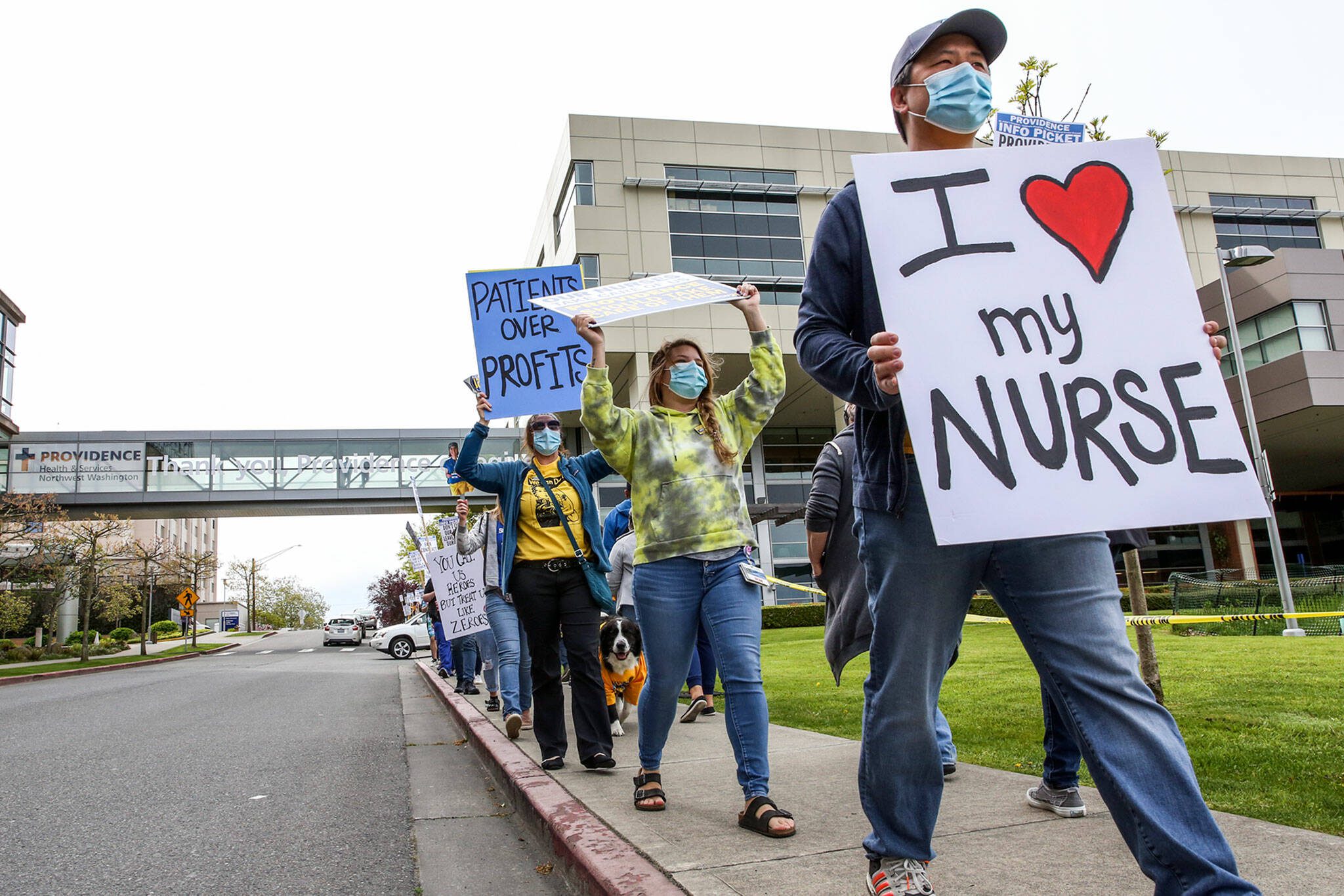 Supporters of nurses march across from Providence Medical Center on May 5, 2021 in in Everett, Washington. (Kevin Clark / The Herald)
