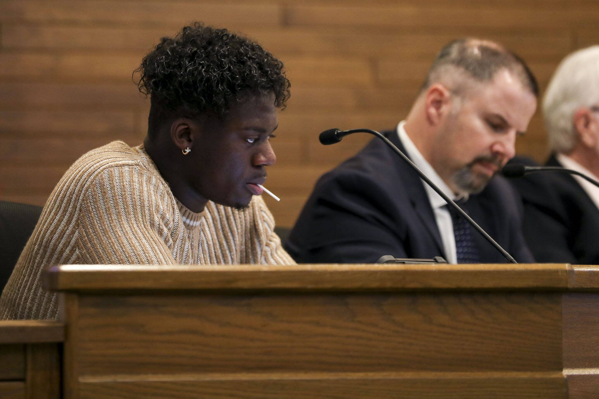 City council member Josh Binda listens and eats a sucker during a city council meeting at Lynnwood City Hall in Lynnwood, Washington on Jan. 23, 2023. (Annie Barker / The Herald)