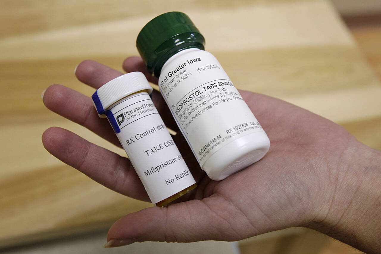 Bottles of abortion pills mifepristone (left) and misoprostol are shown at a clinic in Des Moines, Iowa, in September, 2010. Medication abortions became the preferred method for ending pregnancy in the U.S. even before the Supreme Court overturned Roe v. Wade. Now threatened by a federal court case in Texas, they usually involve taking two prescription medicines days apart; at home or in a clinic. In the U.S., medication abortions usually involve the drugs mifepristone and misoprostol. (Charlie Neibergall / Associated Press file photo)