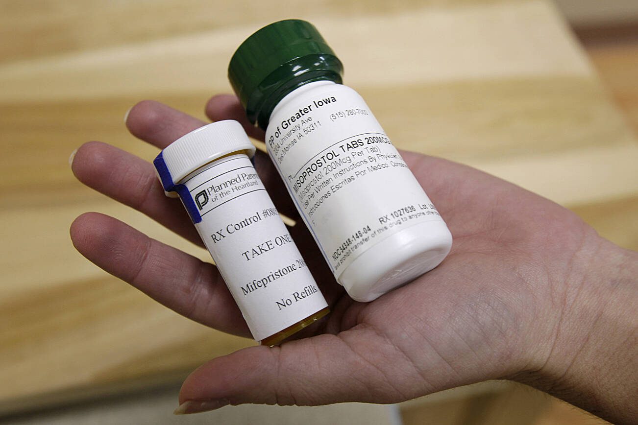 FILE - Bottles of abortion pills mifepristone, left, and misoprostol, right, at a clinic in Des Moines, Iowa, Sept. 22, 2010. Medication abortions became the preferred method for ending pregnancy in the U.S. even before the Supreme Court overturned Roe v. Wade. Now threatened by a federal court case in Texas, they usually involve taking two prescription medicines days apart — at home or in a clinic. In the U.S., medication abortions usually involve the drugs mifepristone and misoprostol. (AP Photo/Charlie Neibergall, File)