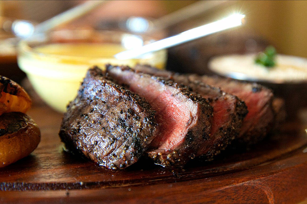 Fillet, cooked rare, is presented on The Associate, which is the less costly of two dinner boards at Rare Society on Tuesday, April 25, 2023, in Mill Creek, Washington. (Ryan Berry / The Herald)