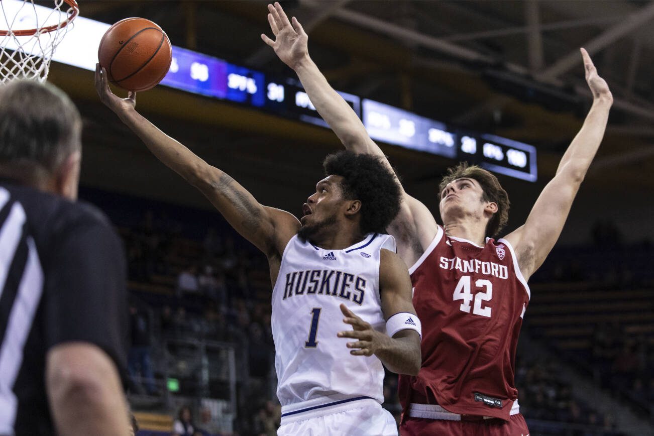 FILE - Washington forward Keion Brooks Jr. shoots against Stanford forward Maxime Raynaud during the second half of an NCAA college basketball game Thursday, Jan. 12, 2023, in Seattle. Brooks was named newcomer of the year in the Pac-12 in voting released by The Associated Press, Tuesday, March 7, 2023. (AP Photo/Stephen Brashear, File)