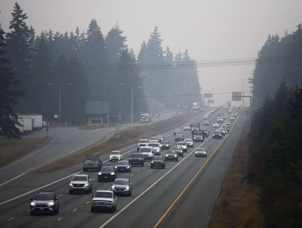 Traffic moves southbound along I-5 through a haze on Oct. 20 in Everett. (Olivia Vanni / The Herald)
