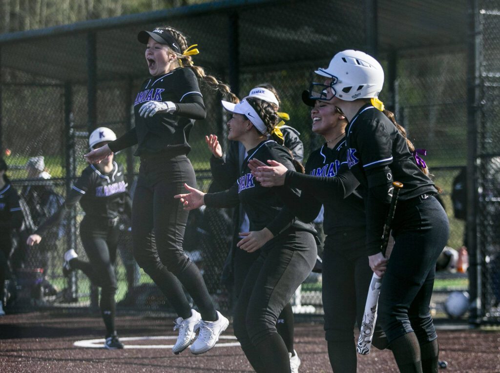 The Kamiak dugout reacts to their teammate hitting a home run during the game against Jackson on Tuesday, April 11, 2023 in Everett, Washington. (Olivia Vanni / The Herald)
