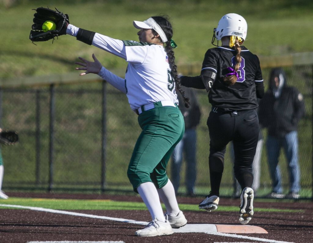 Simone Williams catches the ball to get an out at first during the game against Kamiak on Tuesday, April 11, 2023 in Everett, Washington. (Olivia Vanni / The Herald)
