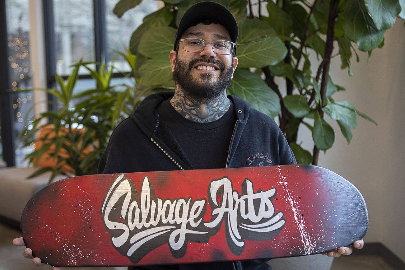 Bruce Rivera, 38, poses for a photo at Graphite Arts Center in Edmonds, Washington on Saturday, April 15, 2023. A silent auction of skateboard art will be held to raise money to kickstart Rivera’s new nonprofit, Salvage Arts. (Annie Barker / The Herald)