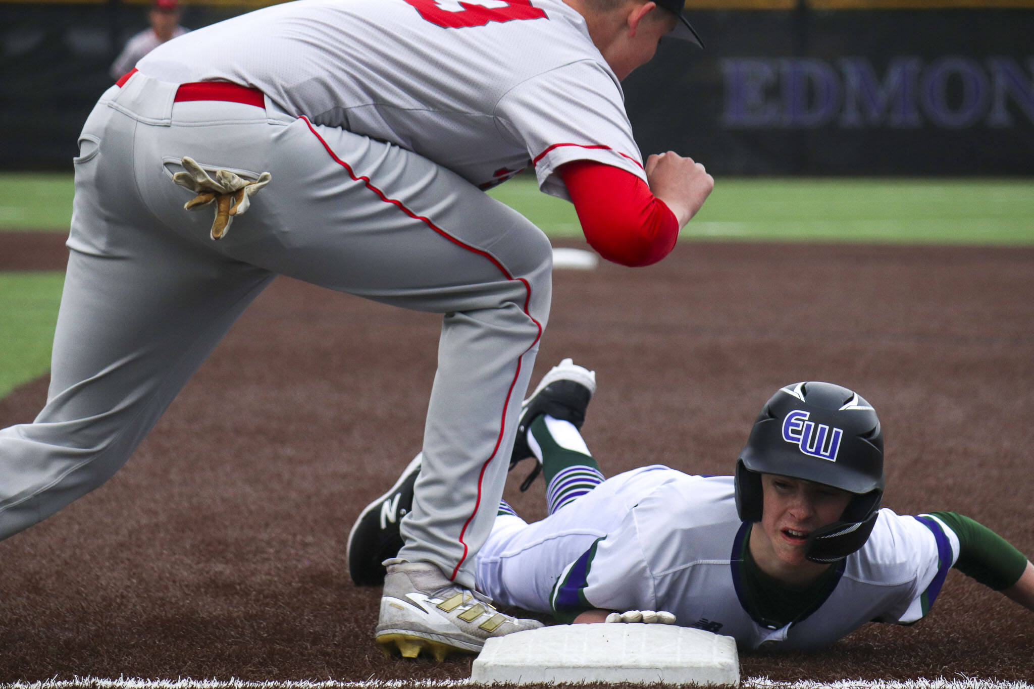 Edmonds-Woodway’s Andreas Simonsen (16) slides back into first during a game against Mountlake Terrace on Thursday at Edmonds-Woodway High School. The Warriors won 5-1. (Annie Barker / The Herald)