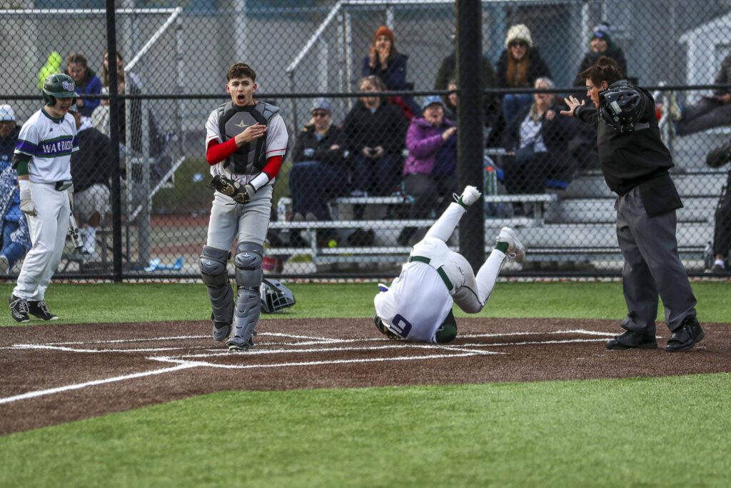 Edmonds-Woodway’s Grant Oliver (6) summersaults through home during a baseball game between Edmonds-Woodway and Mountlake Terrace at Edmonds-Woodway High School in Edmonds, Washington on Thursday, April 13, 2023. The Warriors won, 5-1. (Annie Barker / The Herald)
