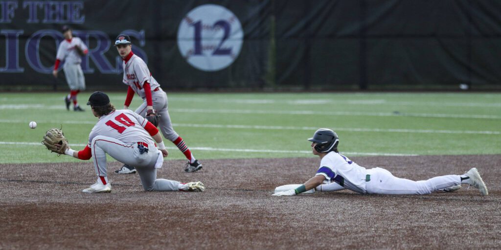Edmonds-Woodway’s Diego Escandon (2) slides into second during a baseball game between Edmonds-Woodway and Mountlake Terrace at Edmonds-Woodway High School in Edmonds, Washington on Thursday, April 13, 2023. The Warriors won, 5-1. (Annie Barker / The Herald)
