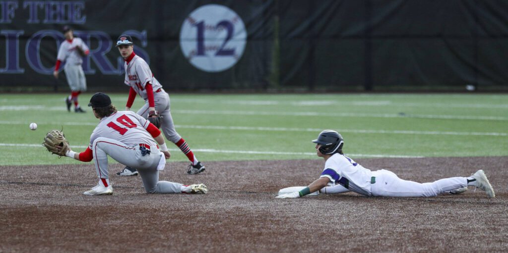 Edmonds-Woodway’s Diego Escandon (2) slides into second during a baseball game between Edmonds-Woodway and Mountlake Terrace at Edmonds-Woodway High School in Edmonds, Washington on Thursday, April 13, 2023. The Warriors won, 5-1. (Annie Barker / The Herald)
