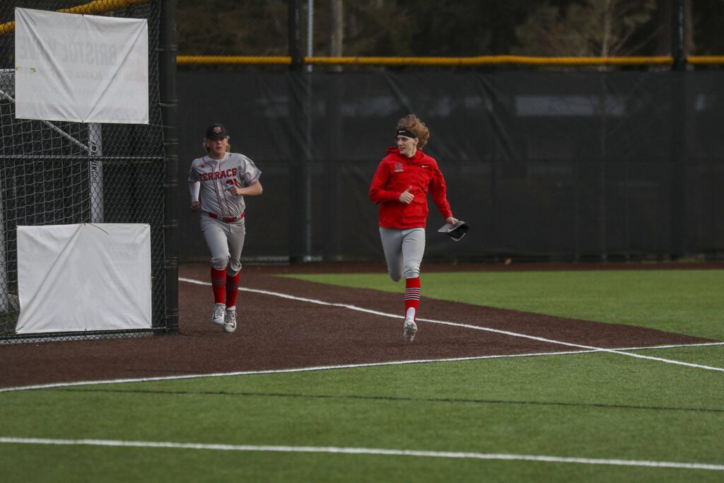 Mountlake Terrace players warm up during a baseball game between Edmonds-Woodway and Mountlake Terrace at Edmonds-Woodway High School in Edmonds, Washington on Thursday, April 13, 2023. The Warriors won, 5-1. (Annie Barker / The Herald)
