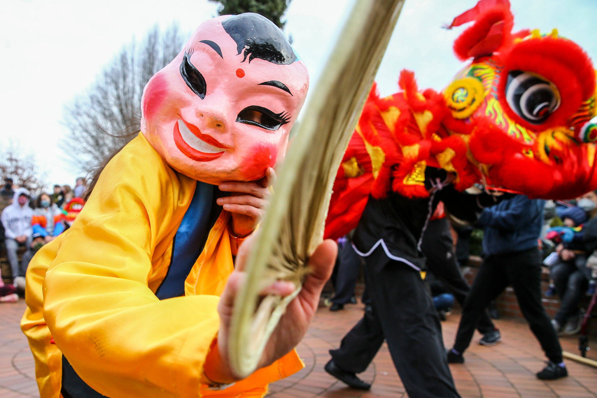 Dai Tou Fut, the big head Buddha, leads the lion dance to celebrate the Lunar New Year on January 29, 2022 in downtown Edmonds, Washington. (Kevin Clark / The Herald)