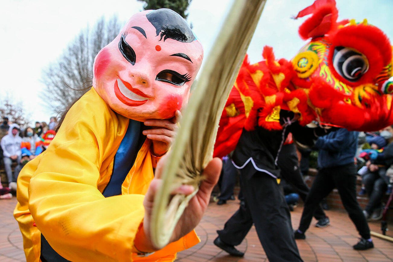 Dai Tou Fut, the big head Buddha, leads the lion dance to celebrate the Lunar New Year Saturday afternoon in downtown Edmonds, Washington on January 29, 2022. (Kevin Clark / The Herald)