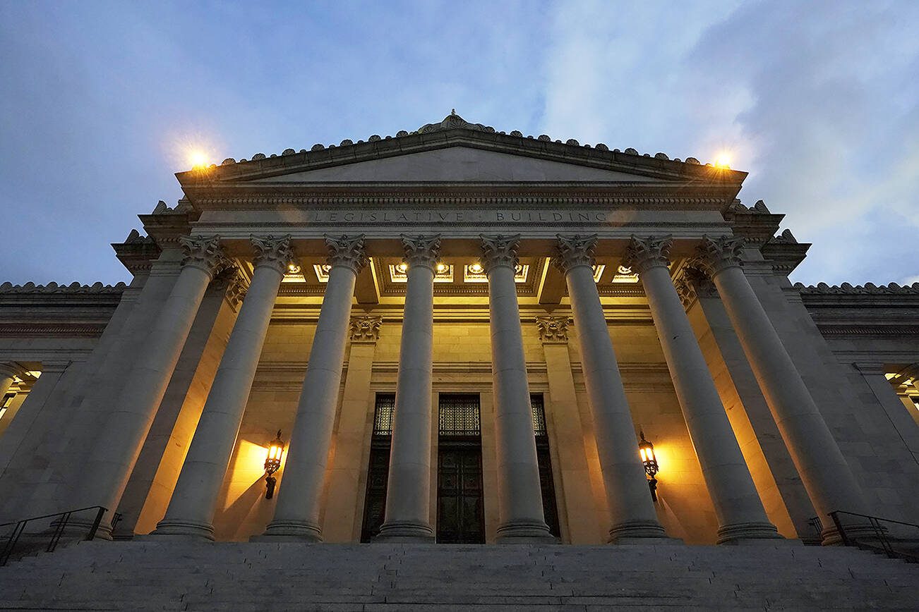 The Legislative Building is seen at dusk Tuesday, Feb. 15, 2022, following a session of the Legislature in Olympia, Wash. (AP Photo/Ted S. Warren)