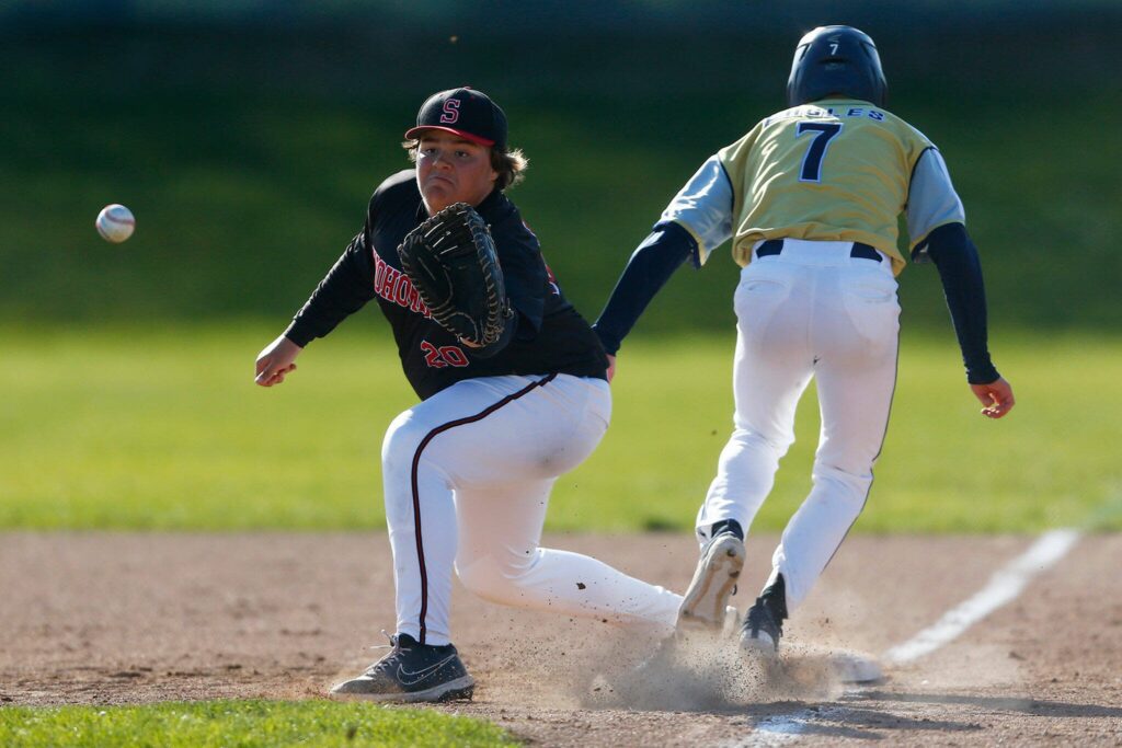 Arlington’s Ty Rusko beats the throw to Snohomish first baseman Tommy Branvold during a matchup against Snohomish on Friday, April 14, 2023, at Earl Torgeson Field in Snohomish, Washington. (Ryan Berry / The Herald)
