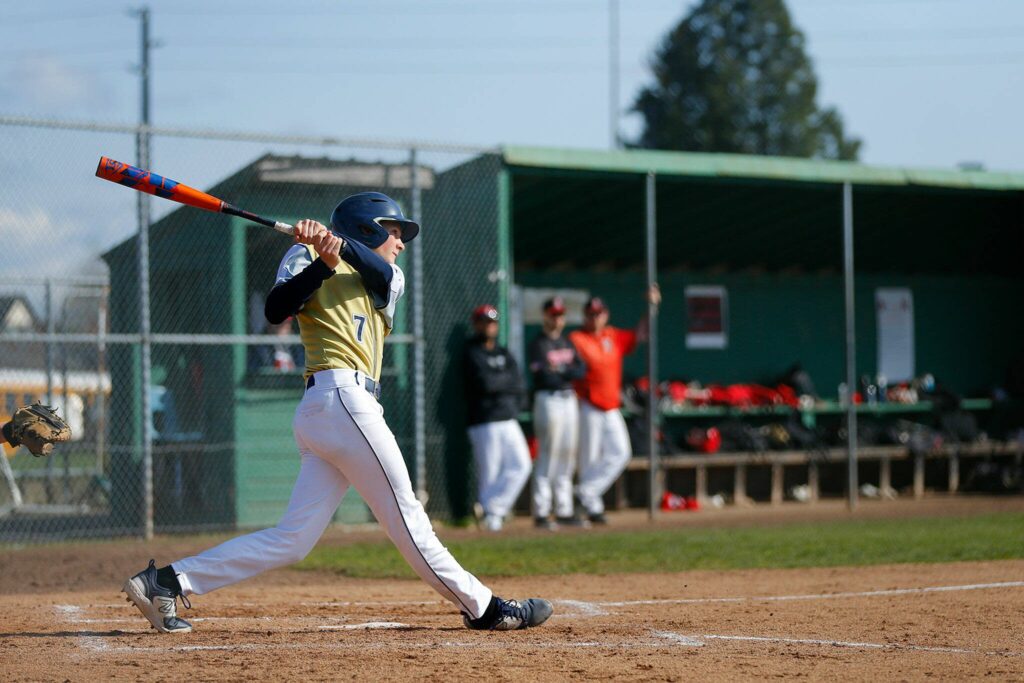 Arlington’s Ty Rusko rips a home run over the right field wall during a matchup against Snohomish on Friday, April 14, 2023, at Earl Torgeson Field in Snohomish, Washington. (Ryan Berry / The Herald)
