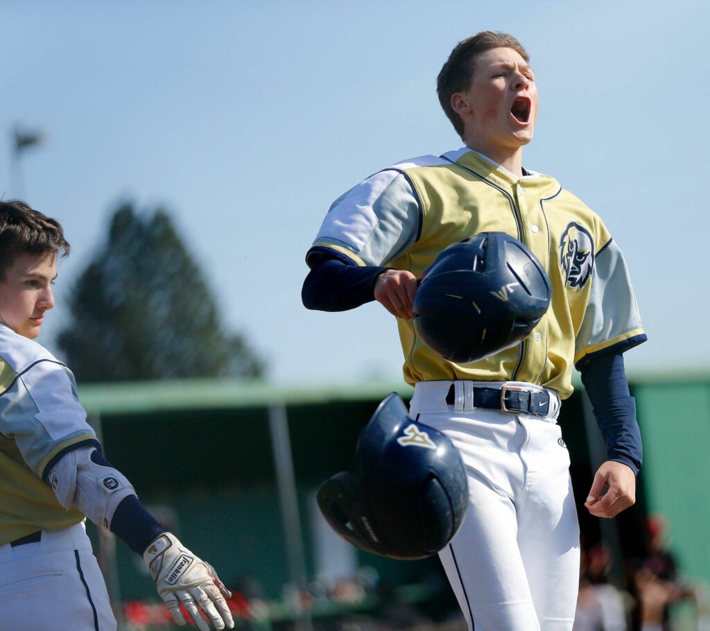 Arlington’s Ty Rusko celebrates his solo shot during a matchup against Snohomish on Friday, April 14, 2023, at Earl Torgeson Field in Snohomish, Washington. (Ryan Berry / The Herald)

